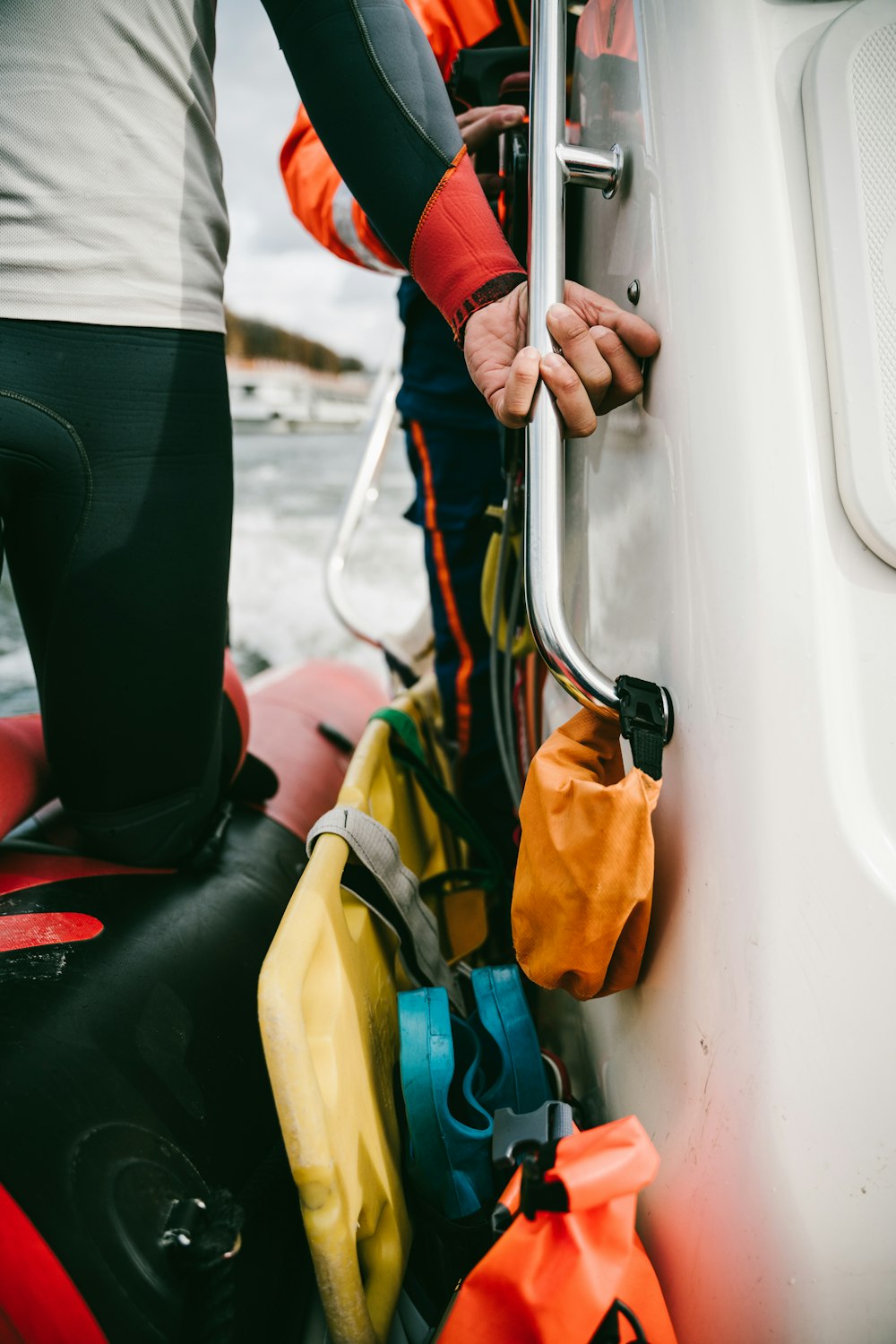 a man holding onto the side of a boat