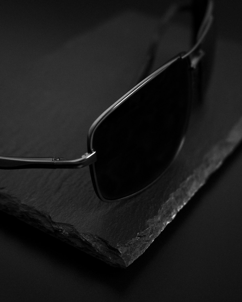 a pair of sunglasses sitting on top of a piece of paper