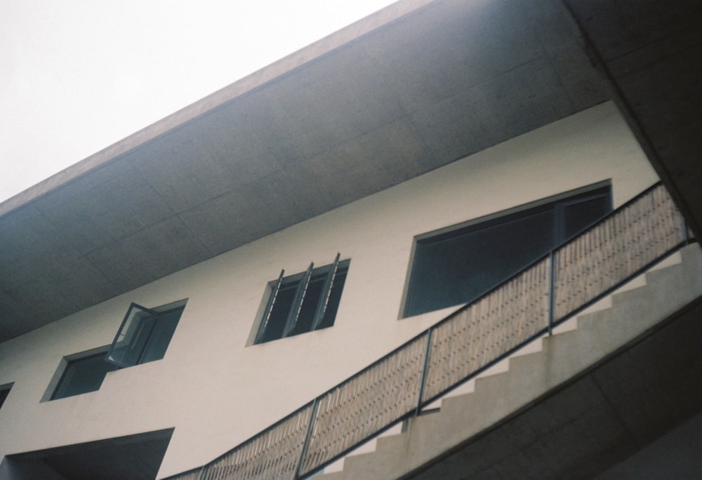 a white building with windows and a balcony