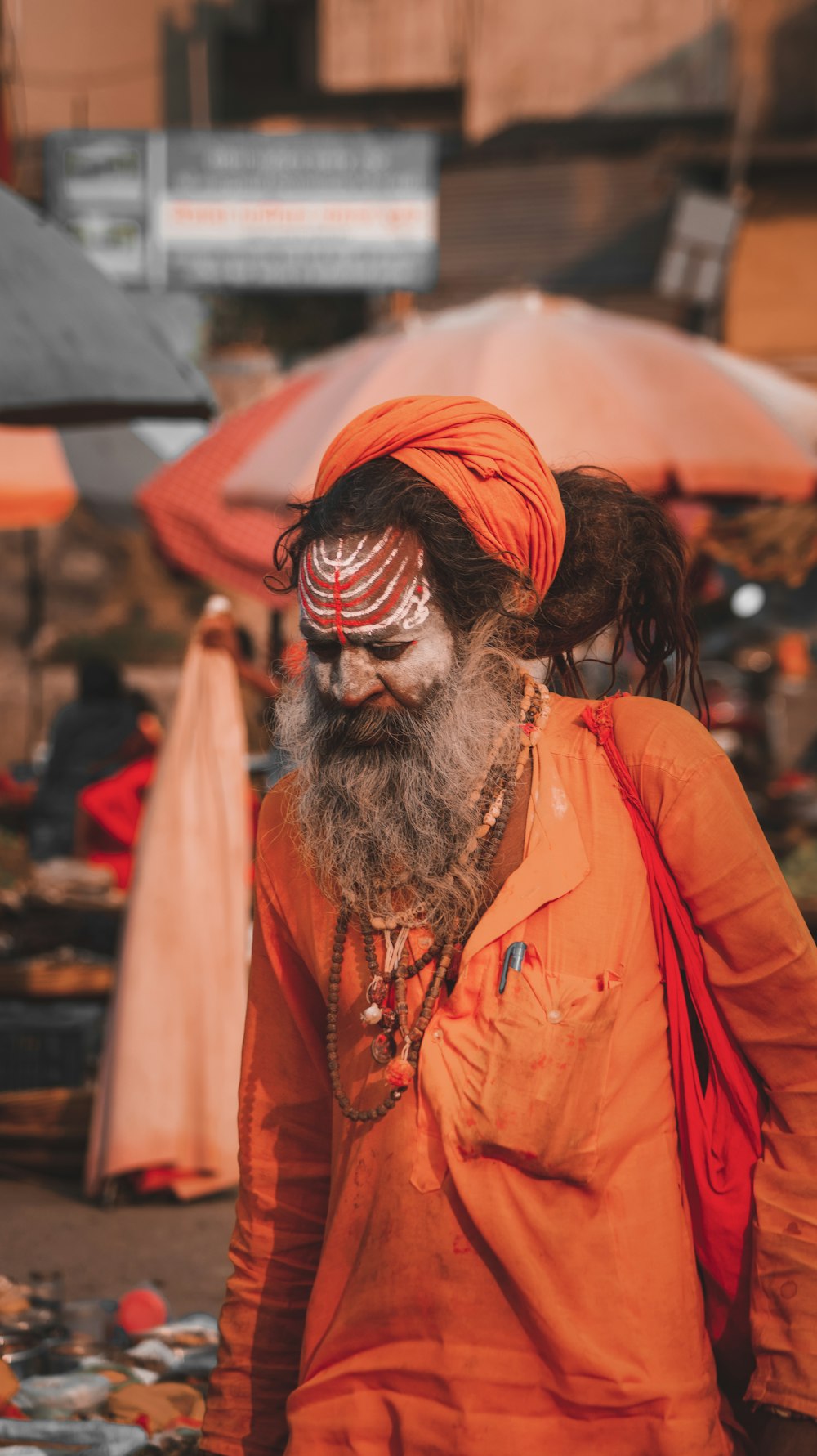 a man in an orange outfit with a long beard