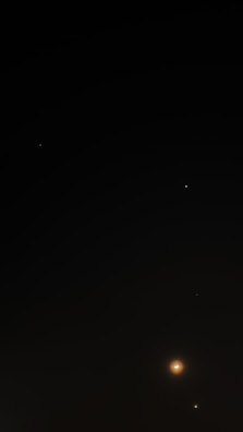 A dark night sky scattered with a few bright celestial bodies, including distant stars and what appears to be a planet or moon with a glowing aura. The prominence of the celestial object at the bottom right creates a sense of depth and distance.