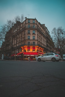 a car parked in front of a tall building