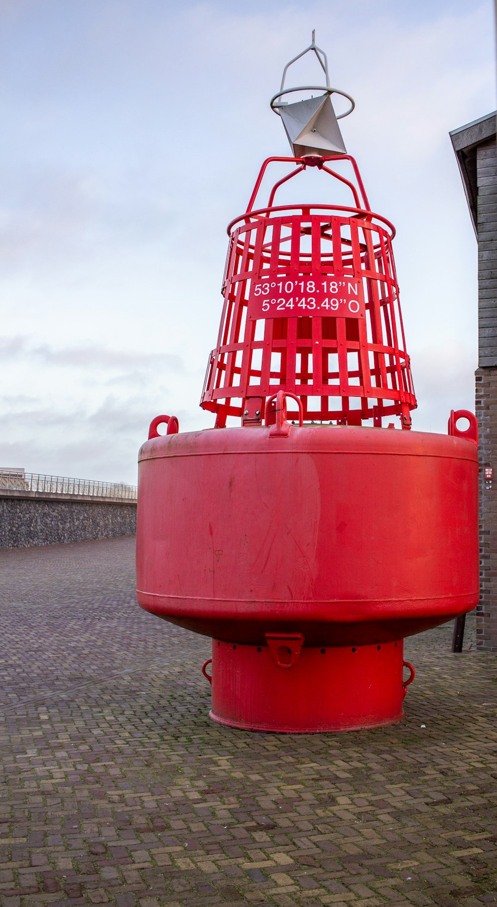 a large red object on a brick walkway