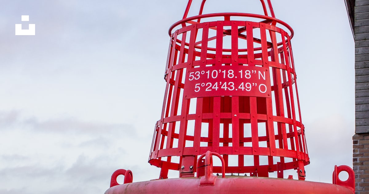 A large red object on a brick walkway photo – Free Harlingen Image on ...