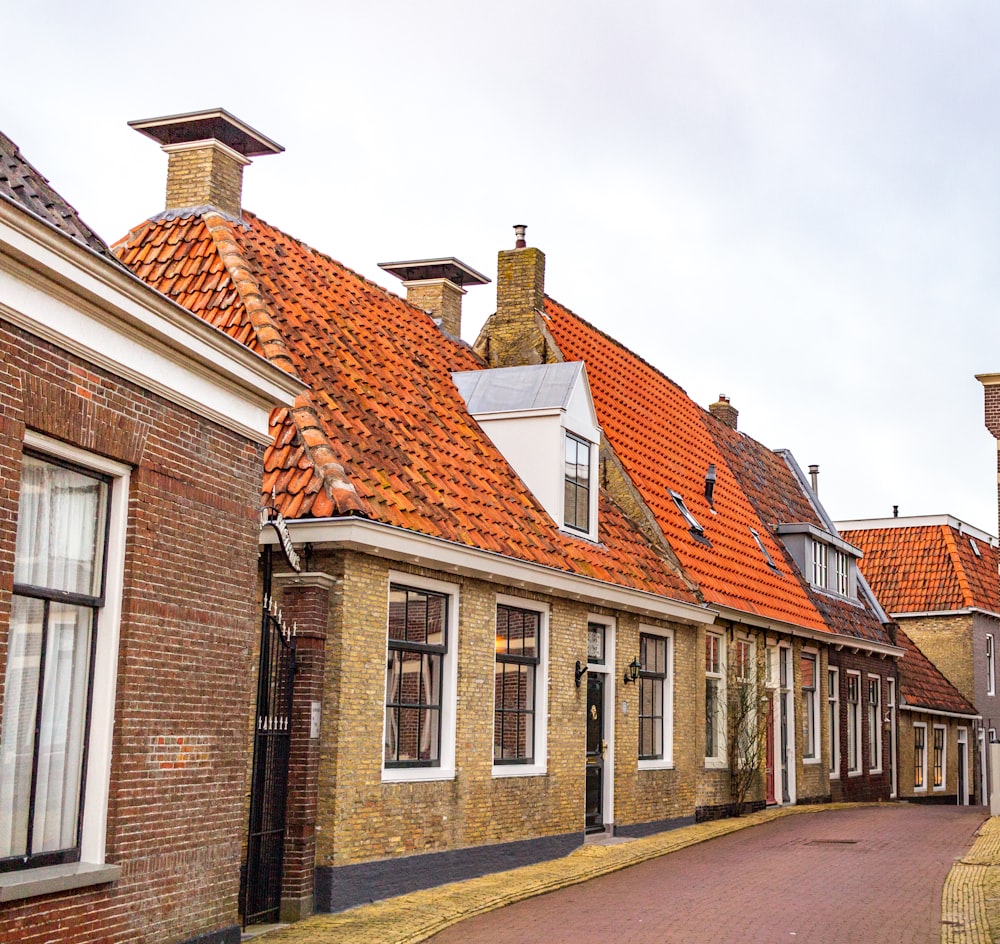 a row of brick buildings with orange tiled roofs