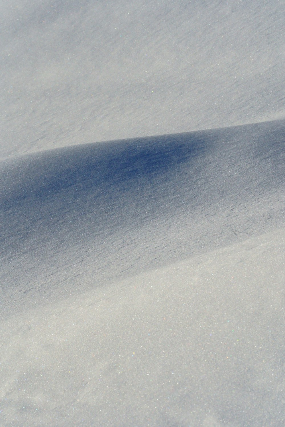 a person riding a snowboard down a snow covered slope