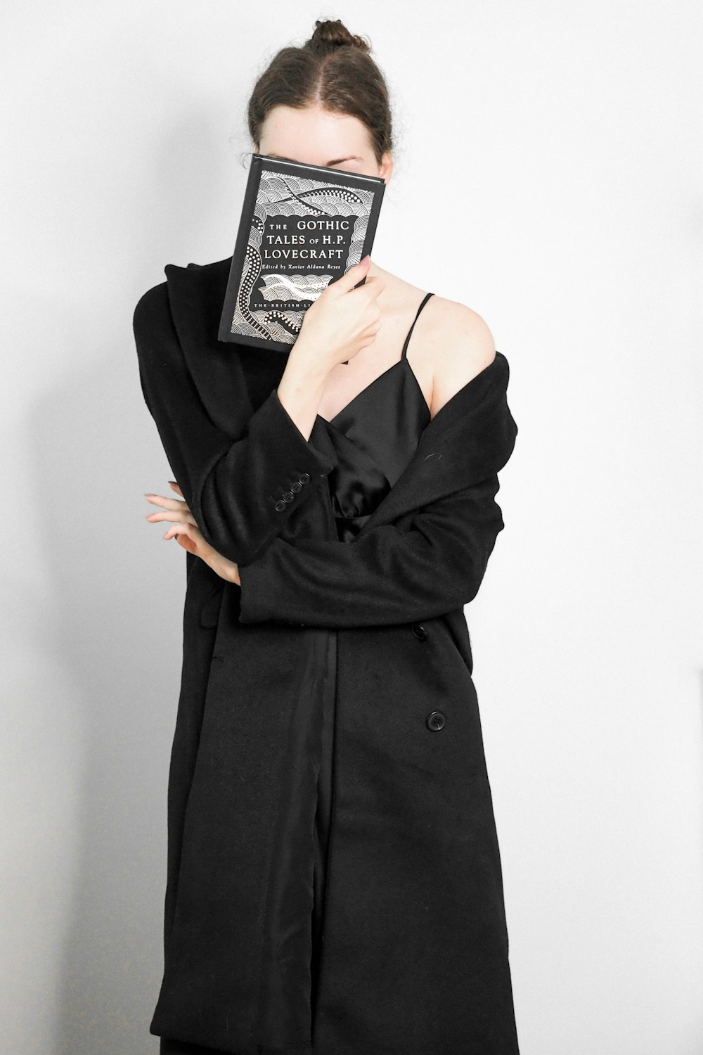 a woman with a book covering her face