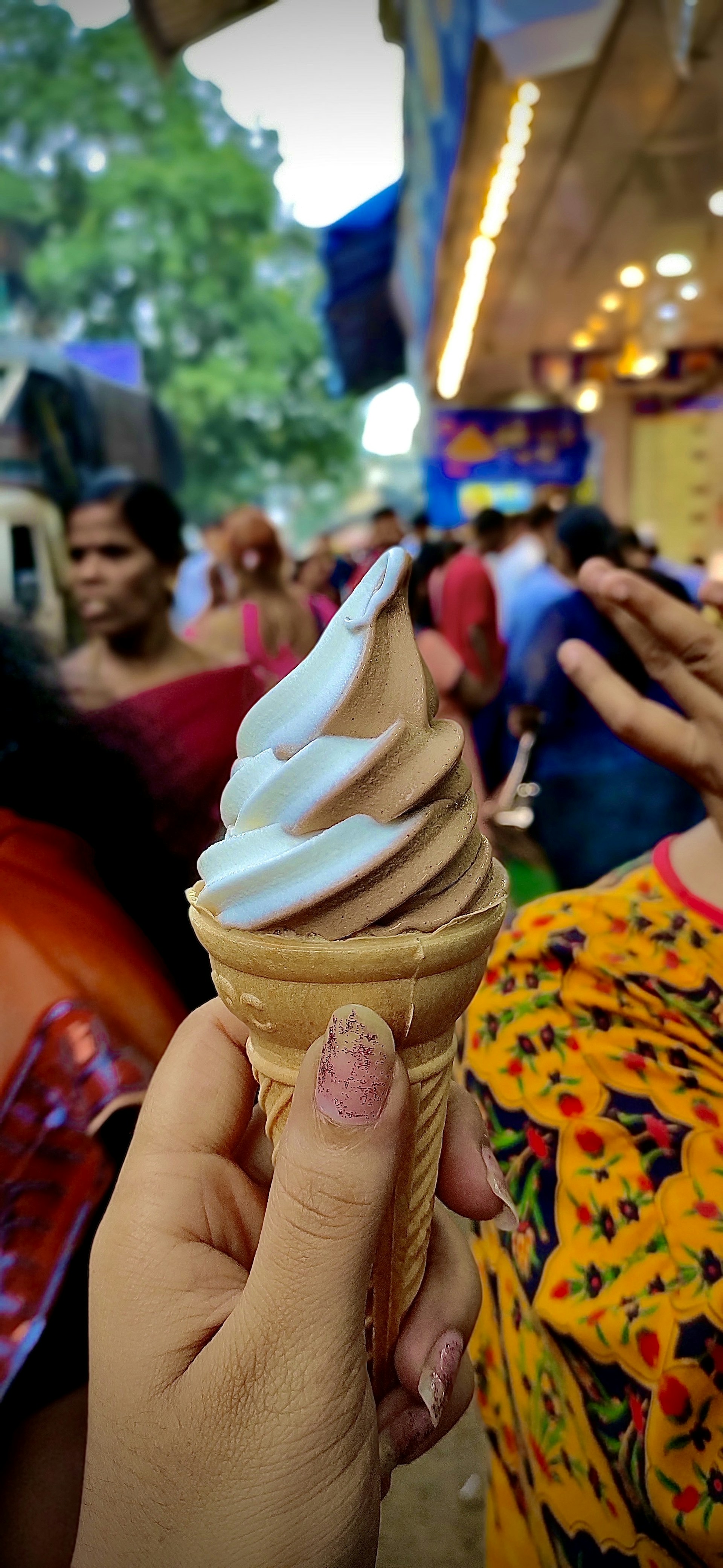 A family enjoying frozen yogurt together at a vibrant outdoor seating area filled with playful decor.