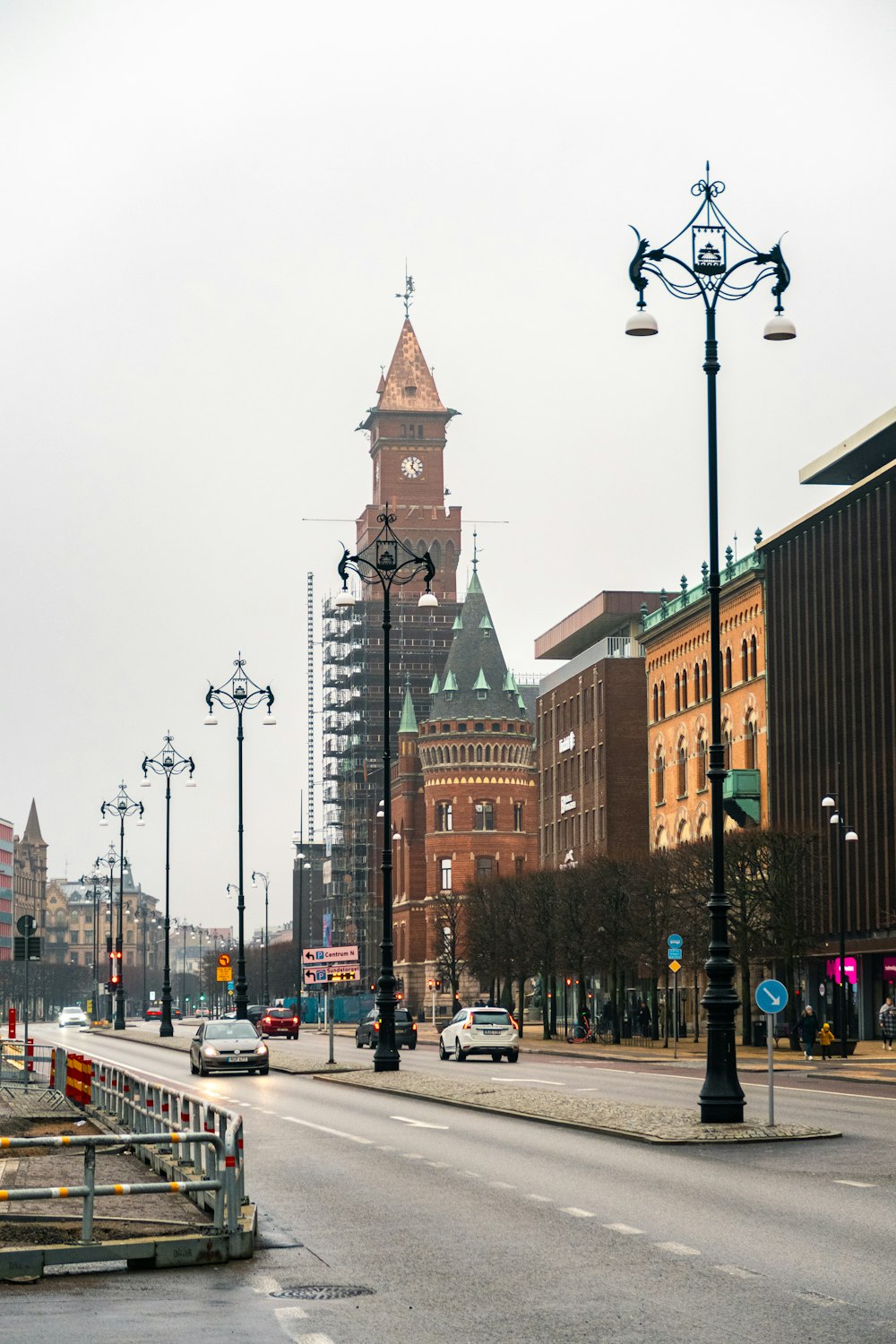 Una calle de la ciudad con una torre del reloj al fondo