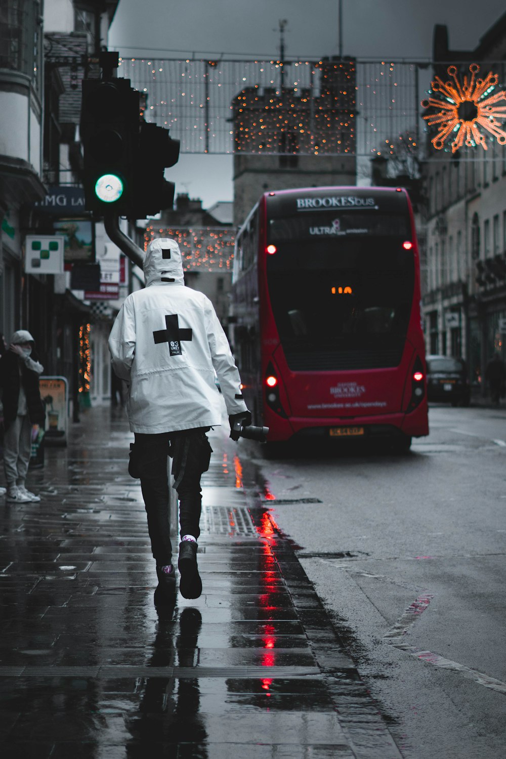 a man walking down the street in the rain