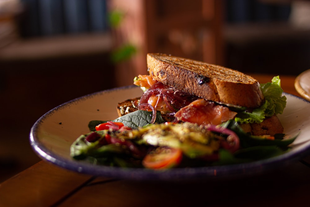 a close up of a plate of food with a sandwich