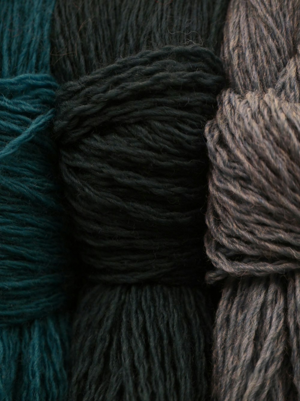 three skeins of yarn in different colors