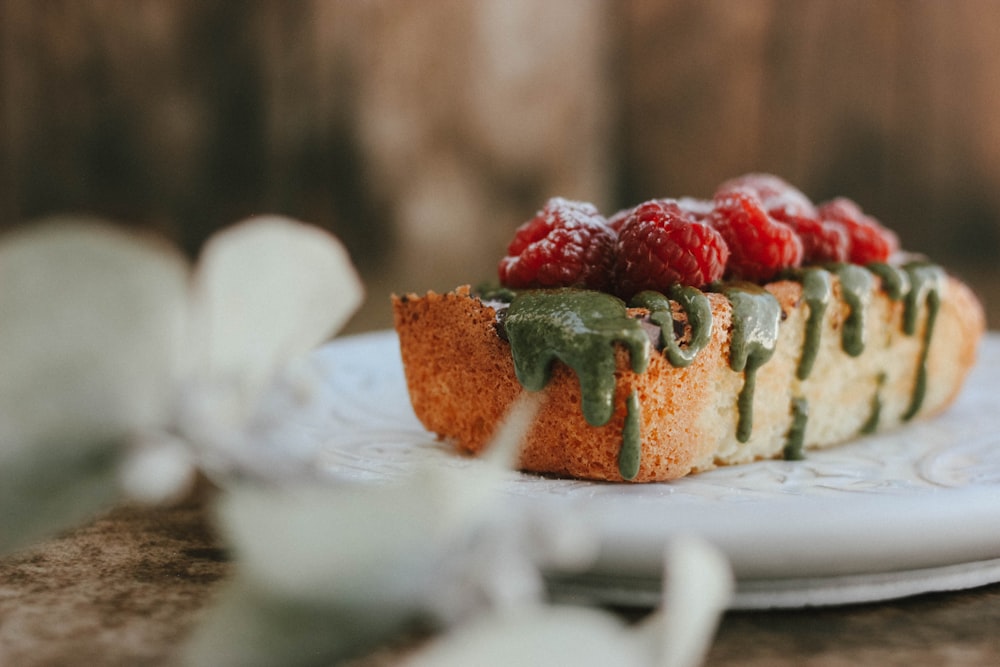 a piece of cake with raspberries on top of it