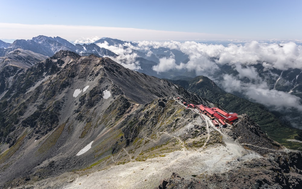 a red train is on the top of a mountain