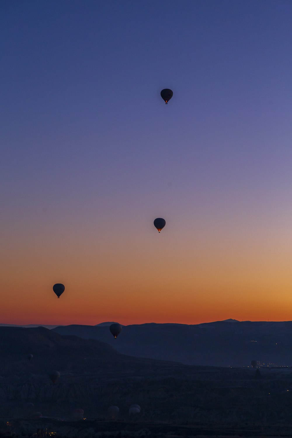 a group of hot air balloons flying in the sky