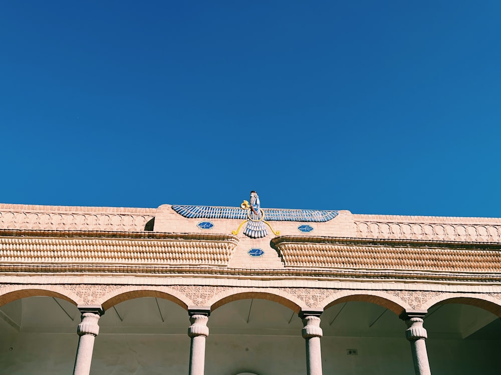 a building with columns and a blue sky in the background