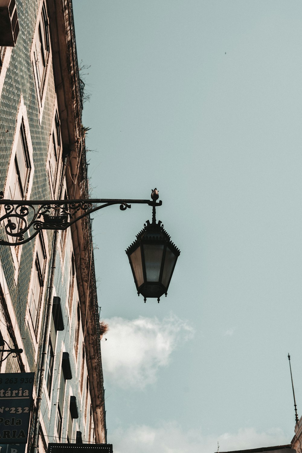 a street light hanging from the side of a building