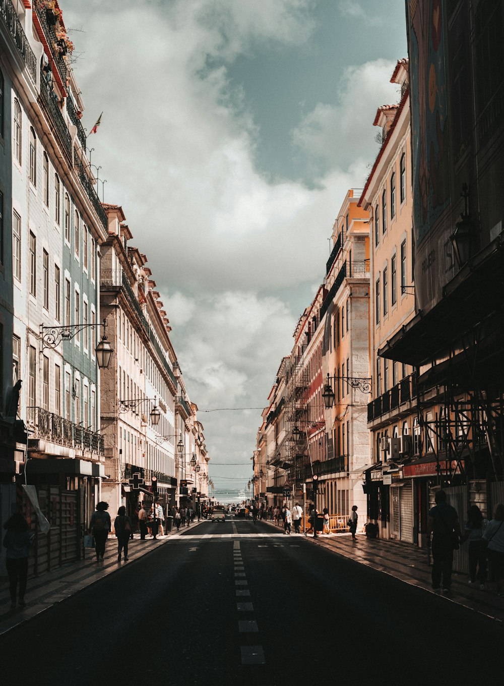 a city street with people walking down it