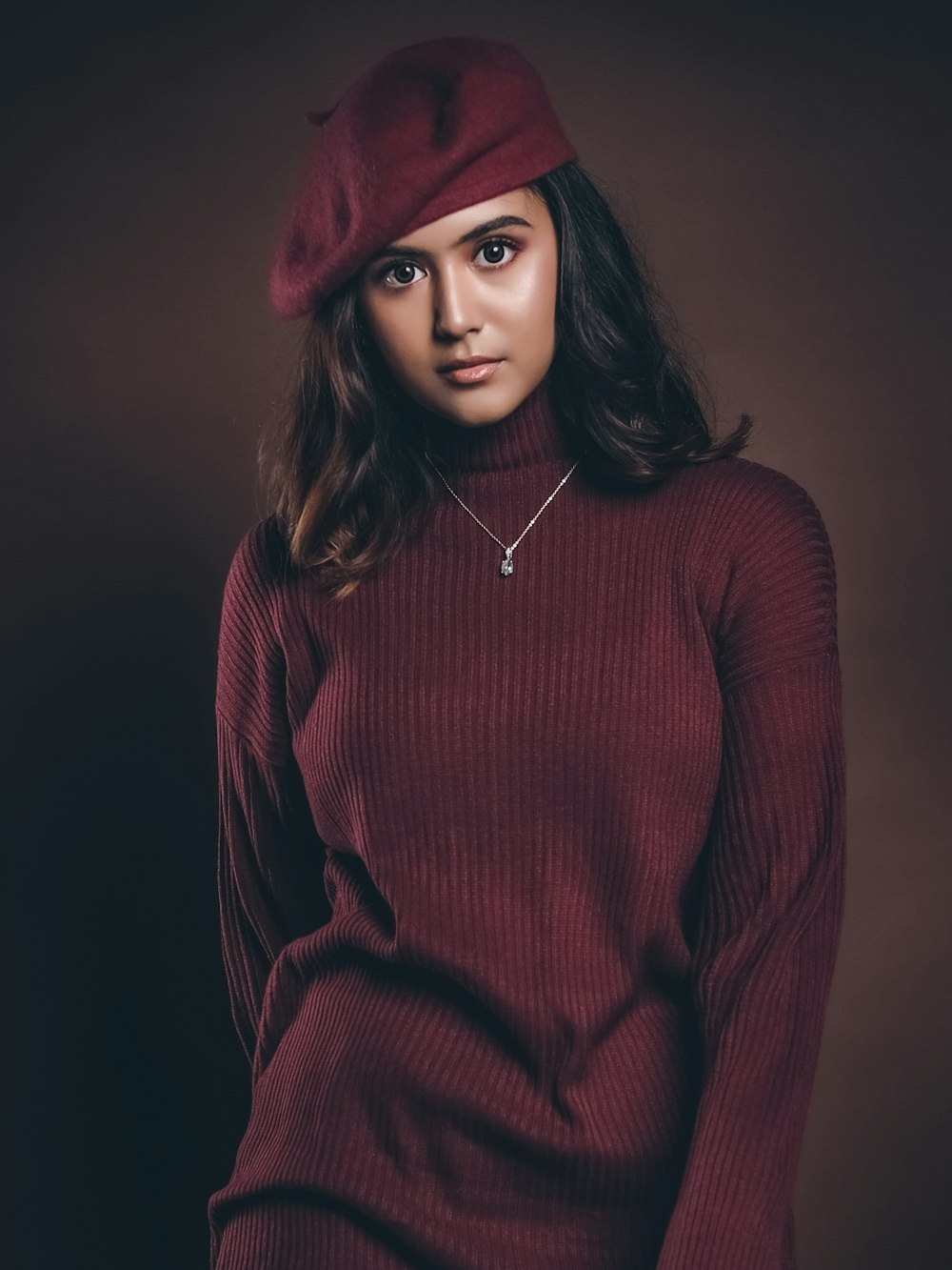 a woman wearing a red sweater and a red hat