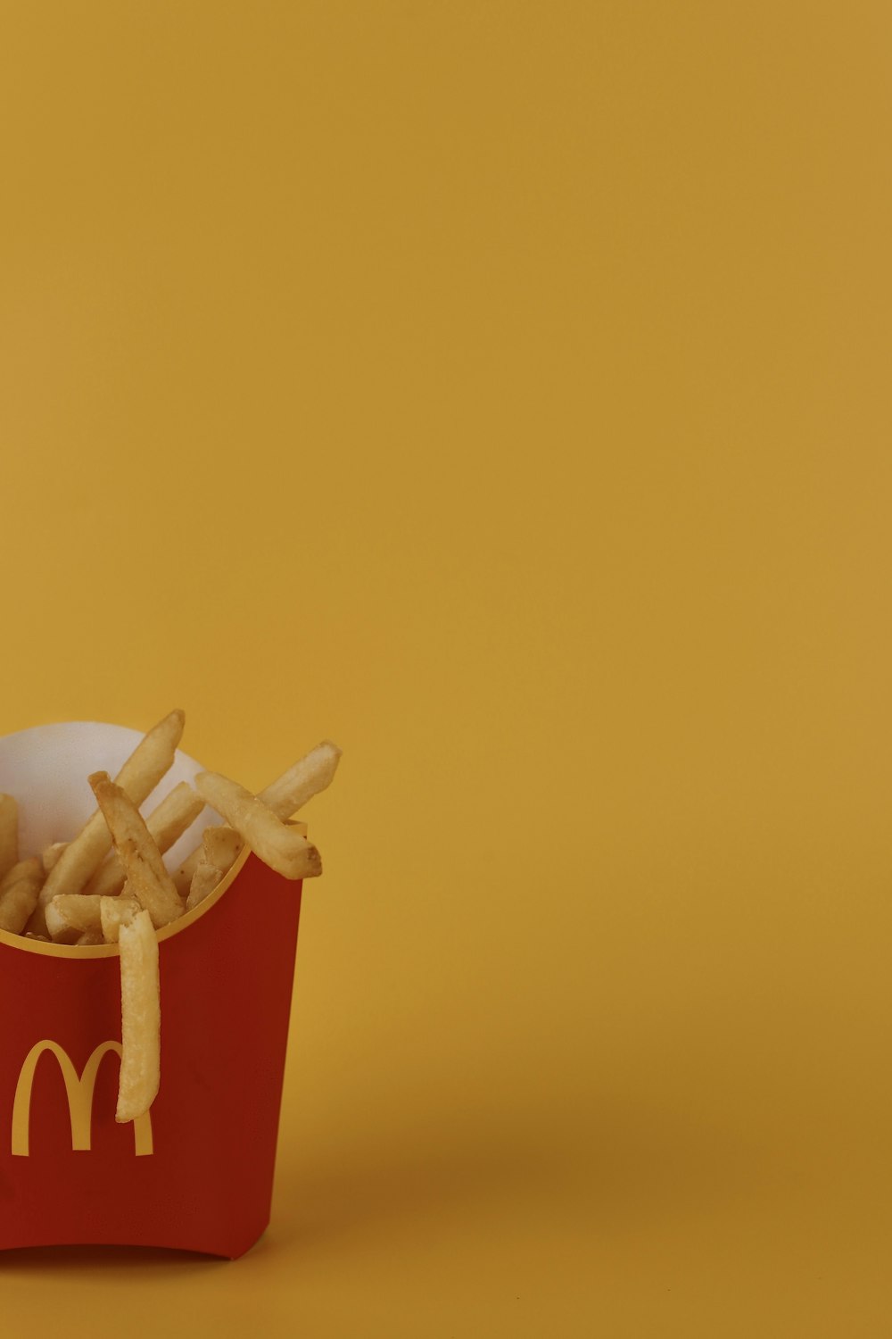 french fries in a red box on a yellow background
