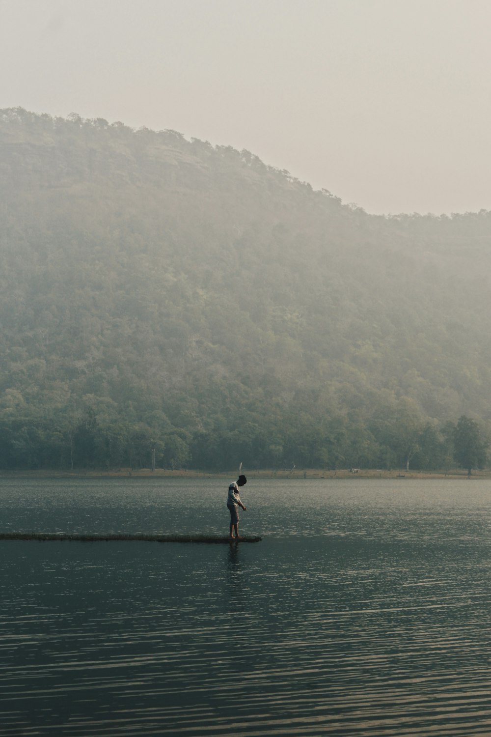 a person standing in the middle of a body of water