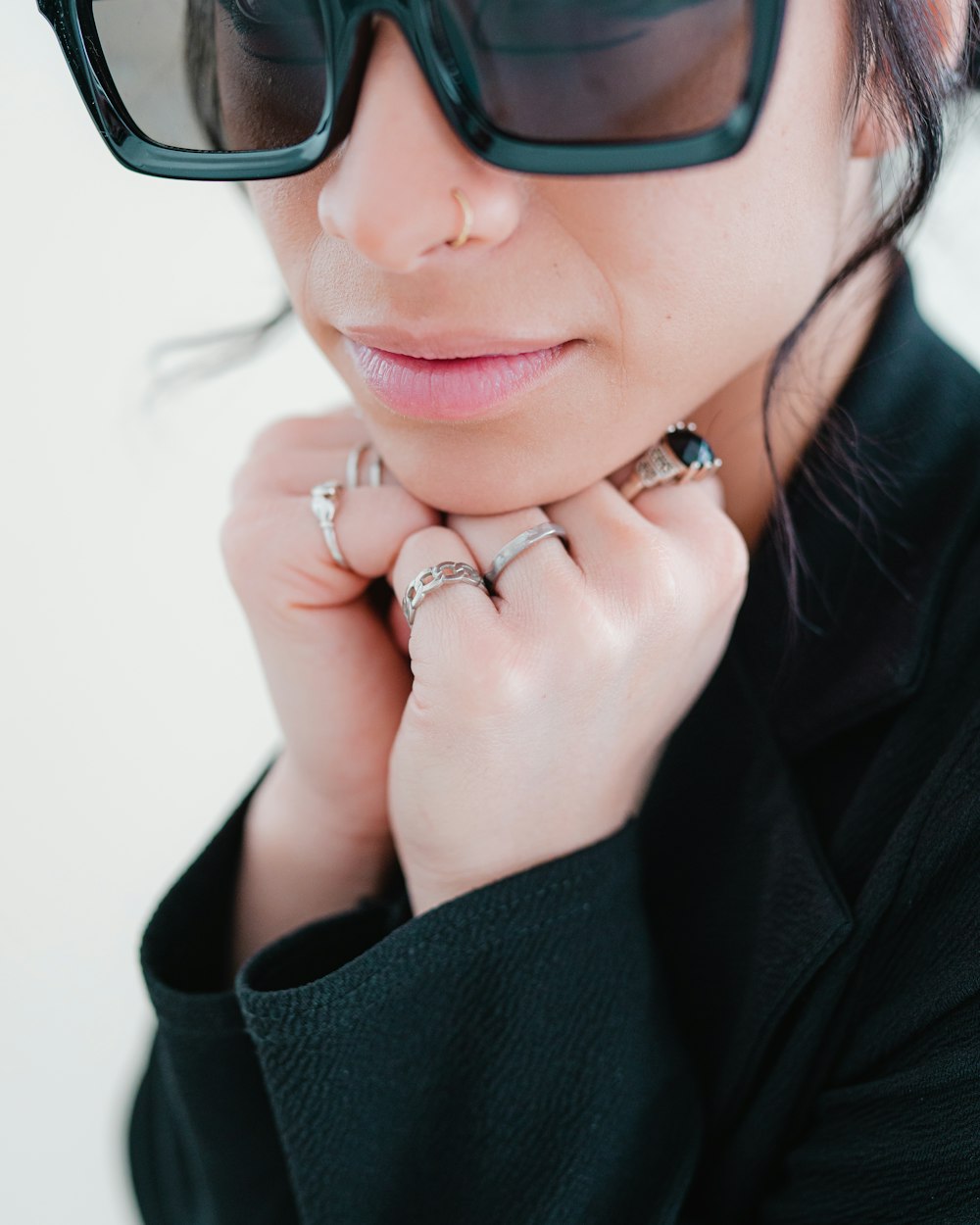 a woman wearing a pair of sunglasses and a ring
