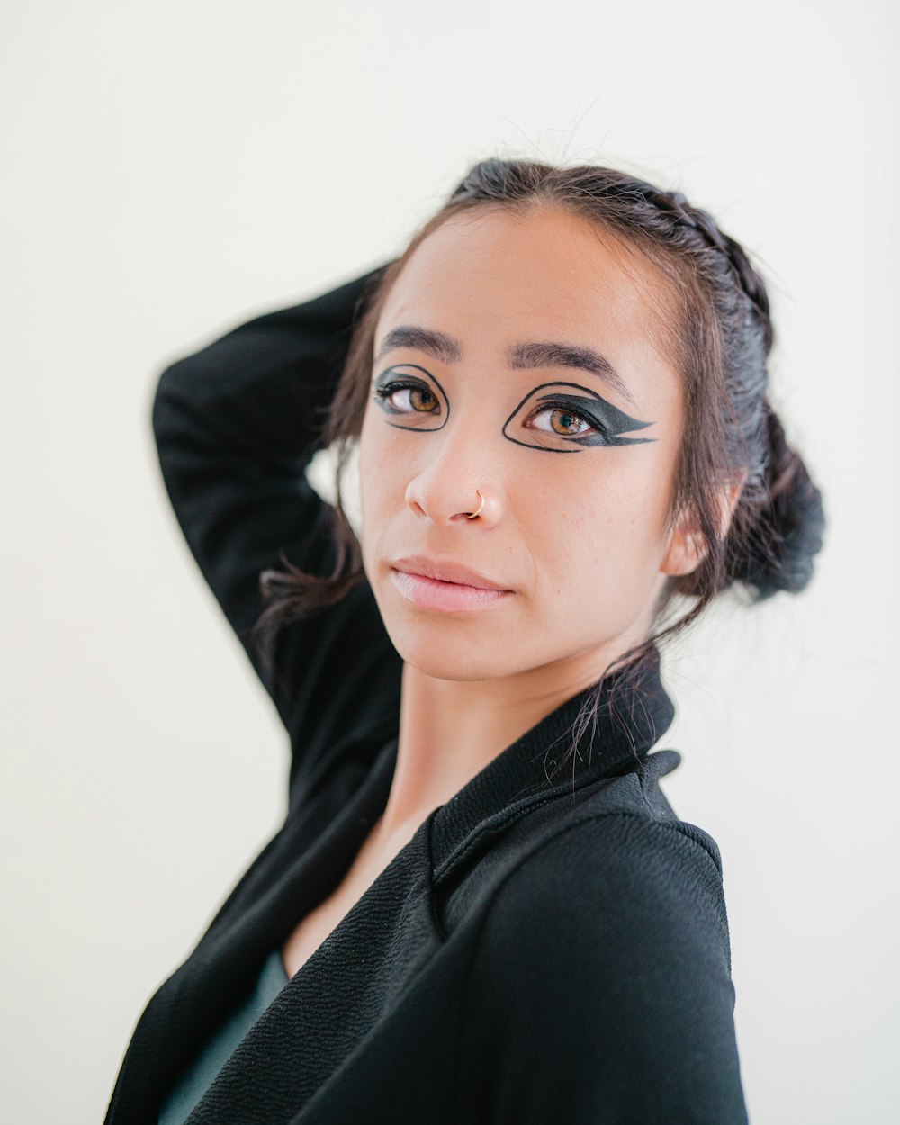 a woman with black eyeliners and a black jacket