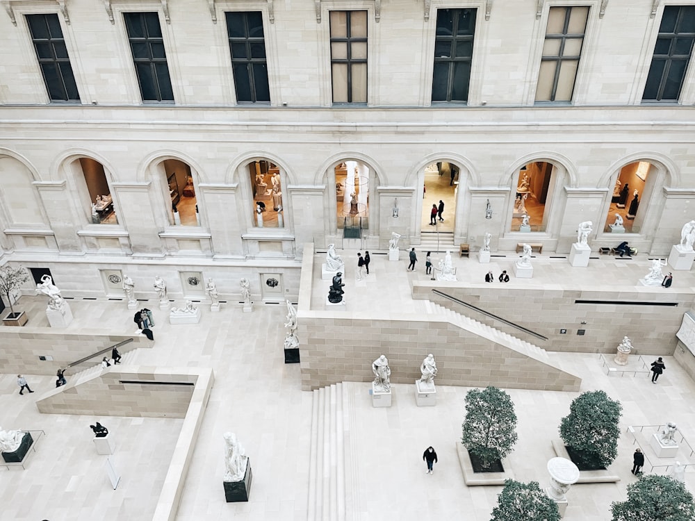 an aerial view of a building with people walking around