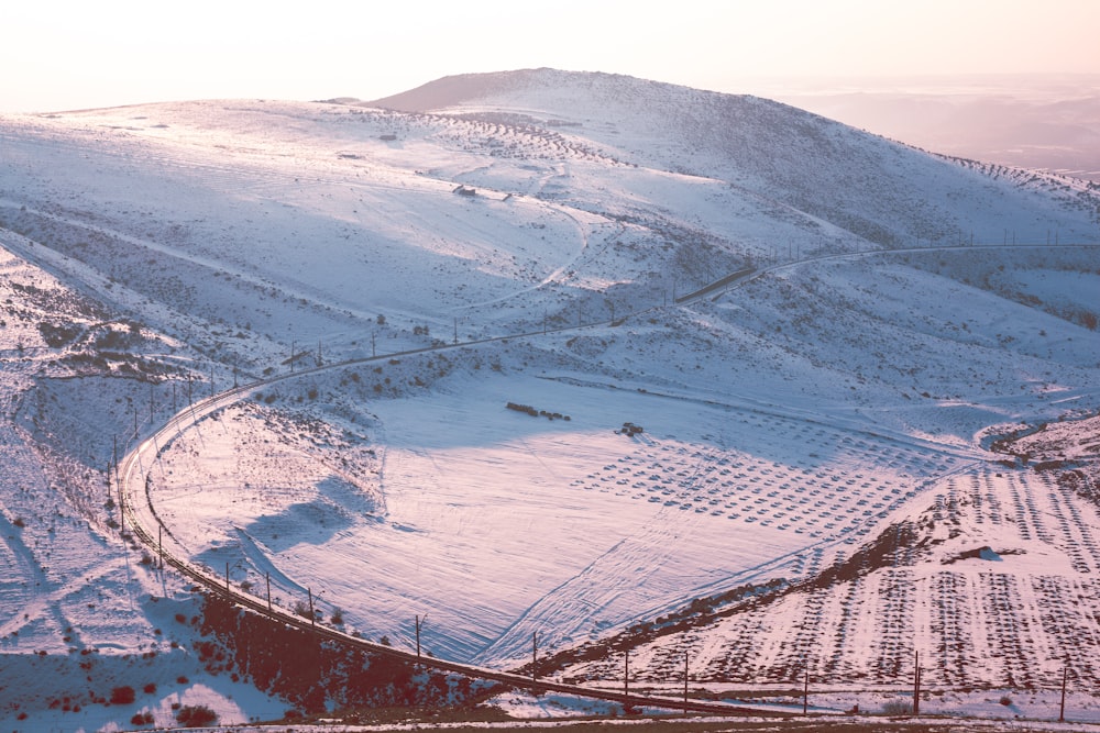 a snow covered hill with a train on it