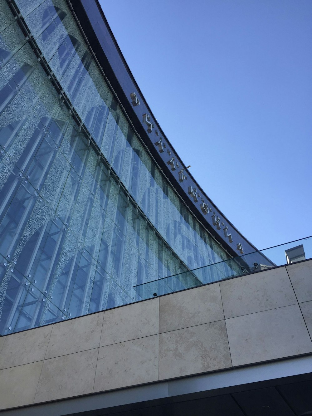 a building with a curved roof and a sky background