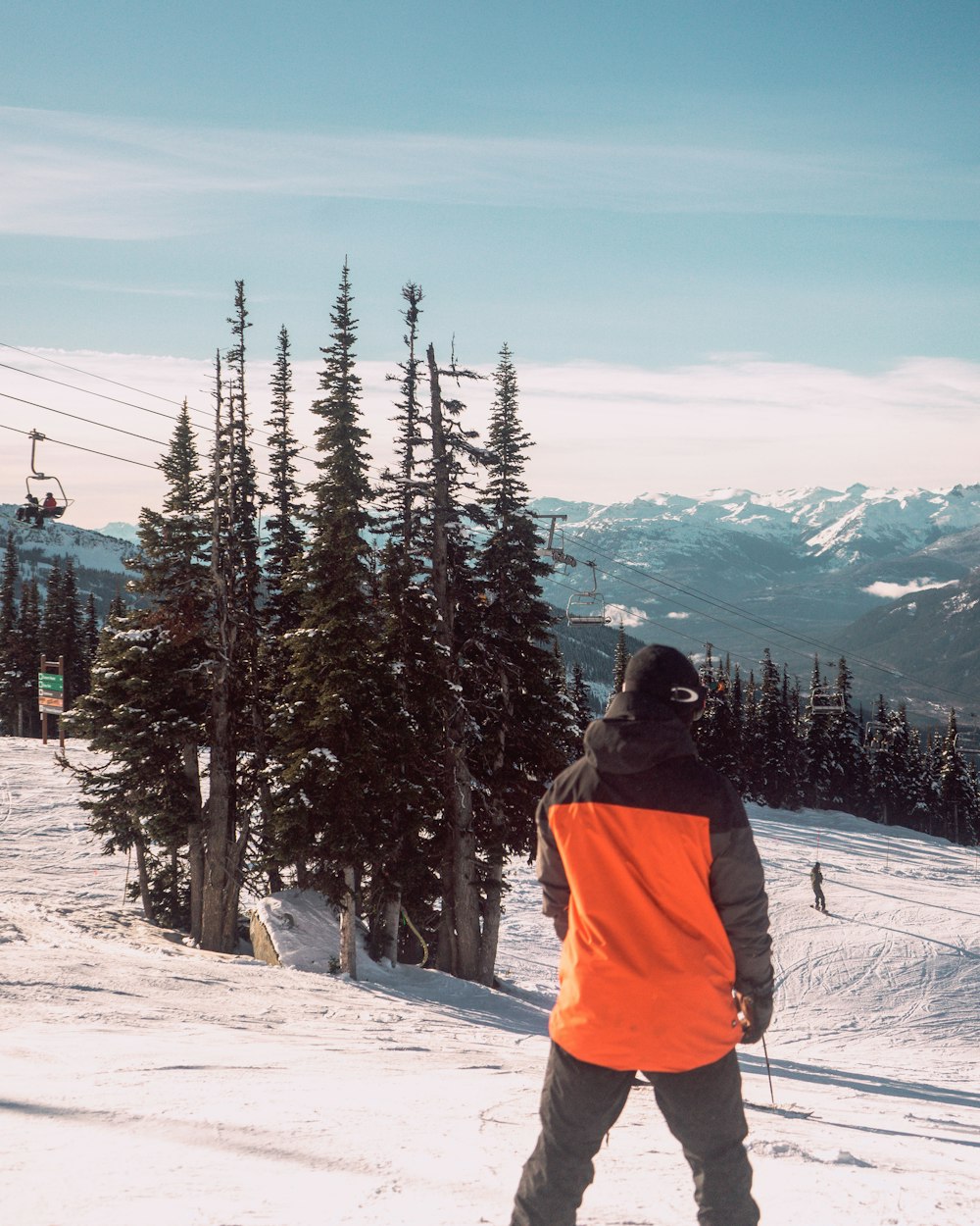 a man standing on top of a snow covered slope