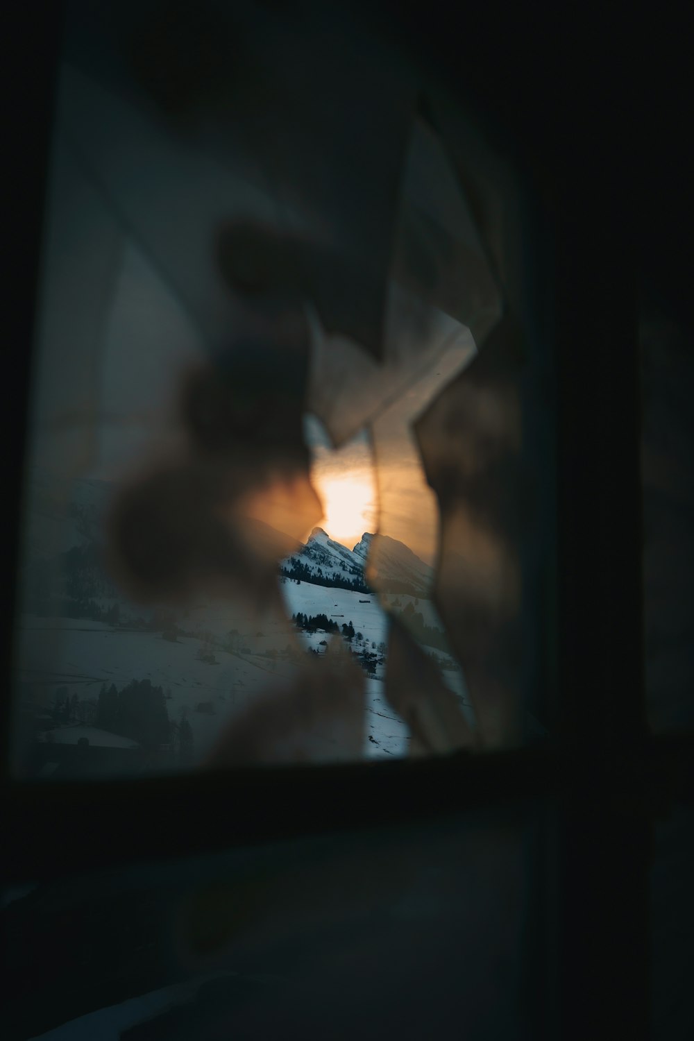 a blurry photo of a mountain seen through a window
