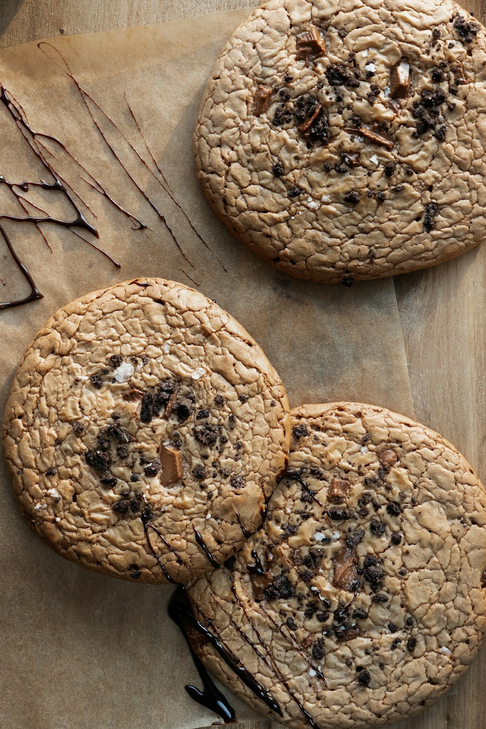 three cookies on a piece of wax paper