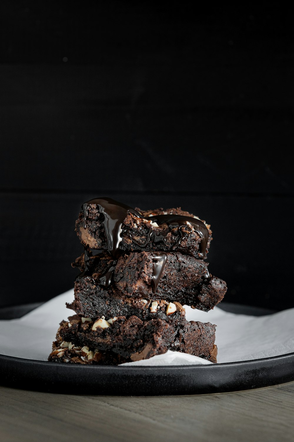 a stack of brownies sitting on top of a white plate