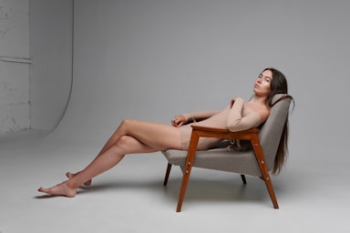 fashion photography,how to photograph diana.; a woman sitting in a chair with her legs crossed