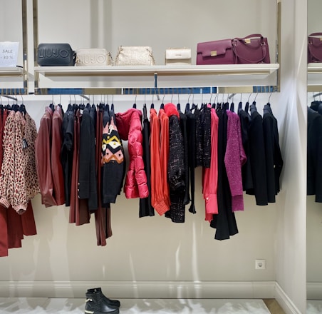 a rack of clothes and shoes in a store