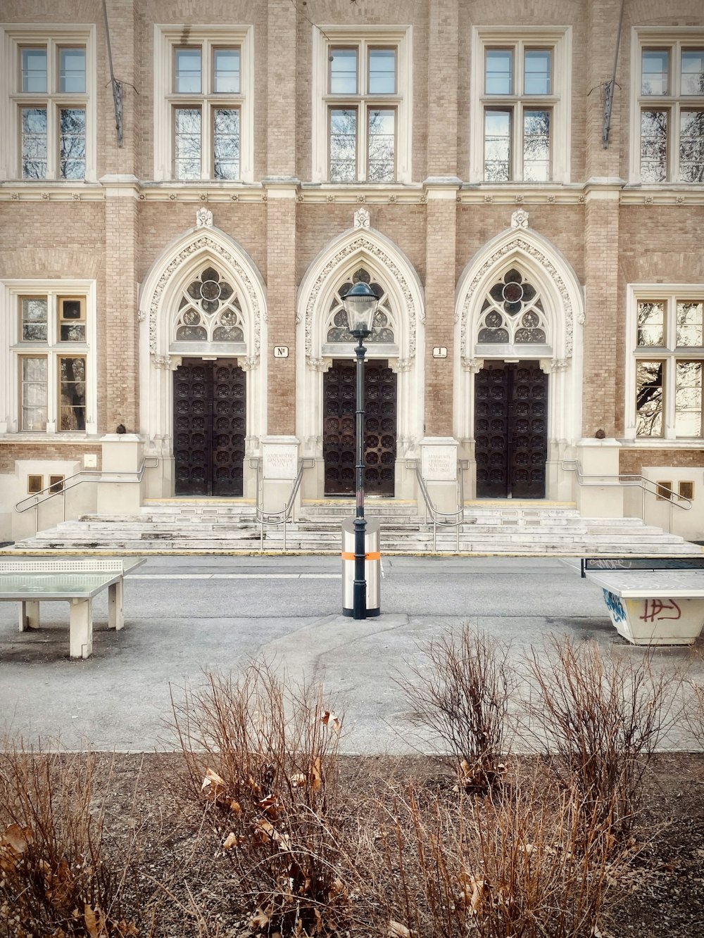 a large building with a bunch of benches in front of it