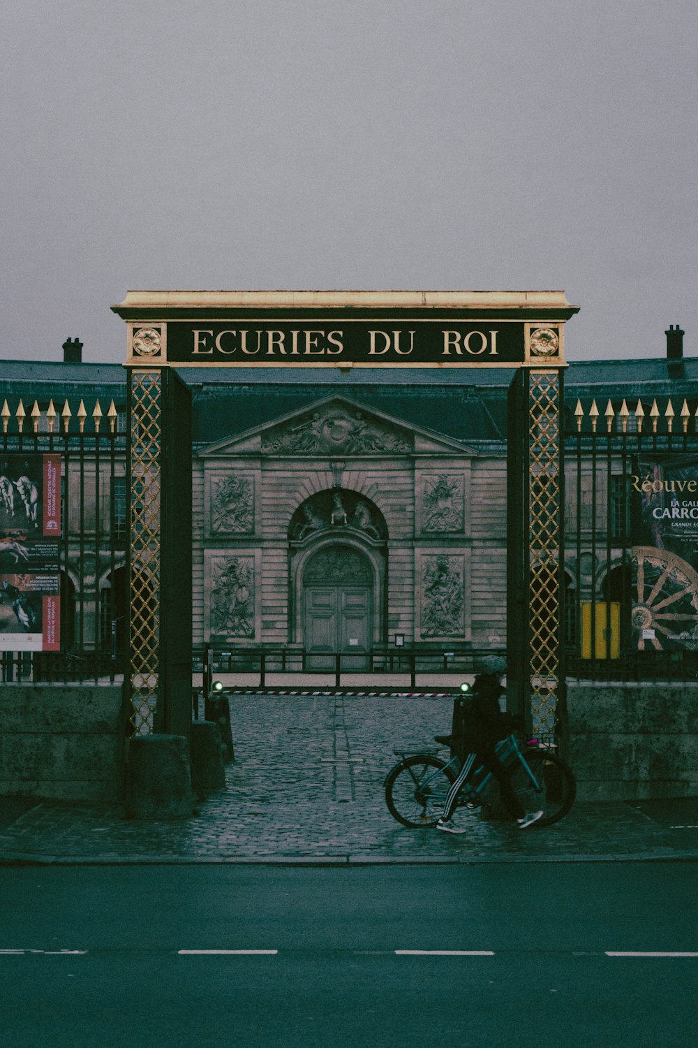 a person riding a bike in front of a building