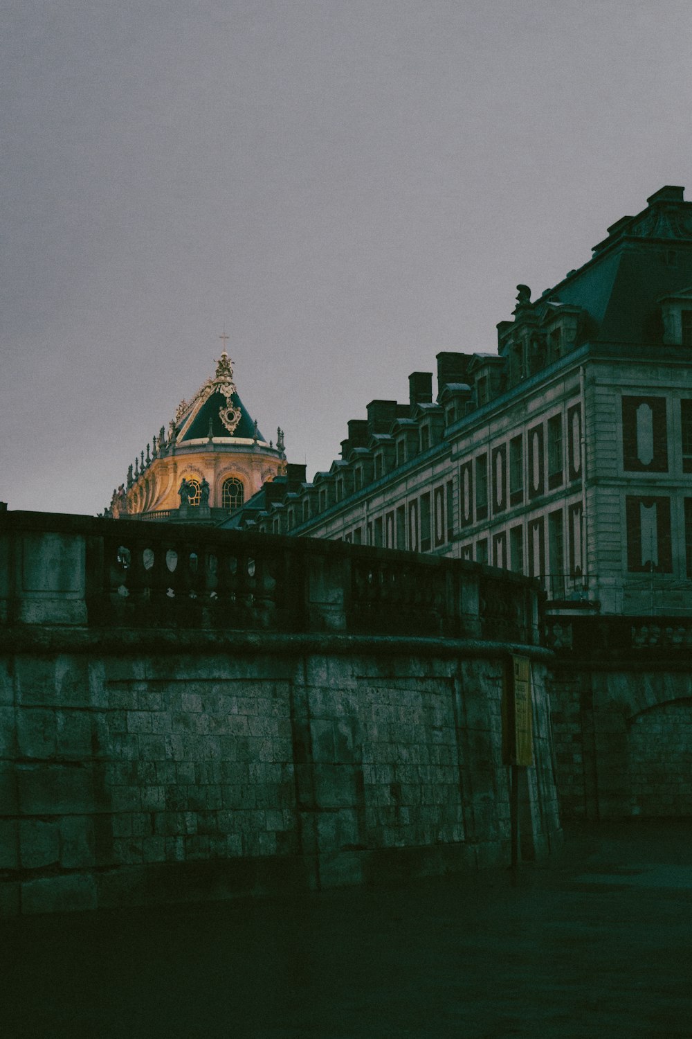 a clock tower on top of a building next to a river