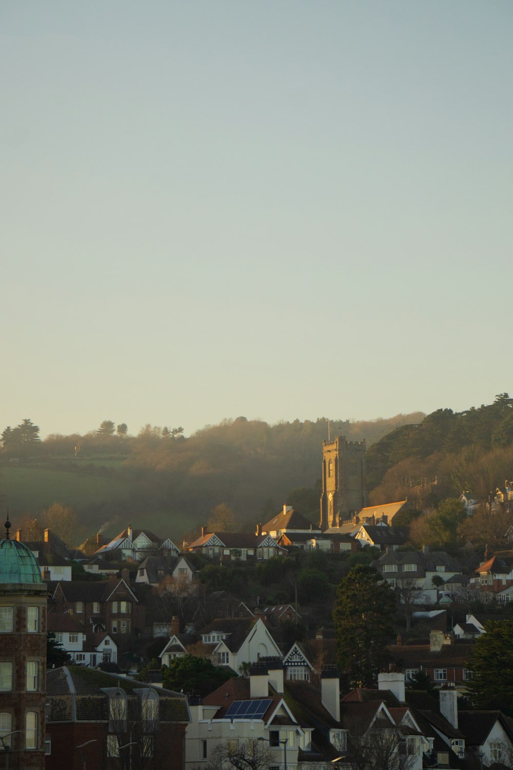 a view of a small town with a church steeple in the background