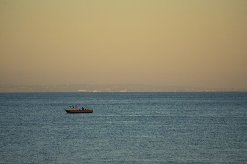 a small boat in the middle of a large body of water