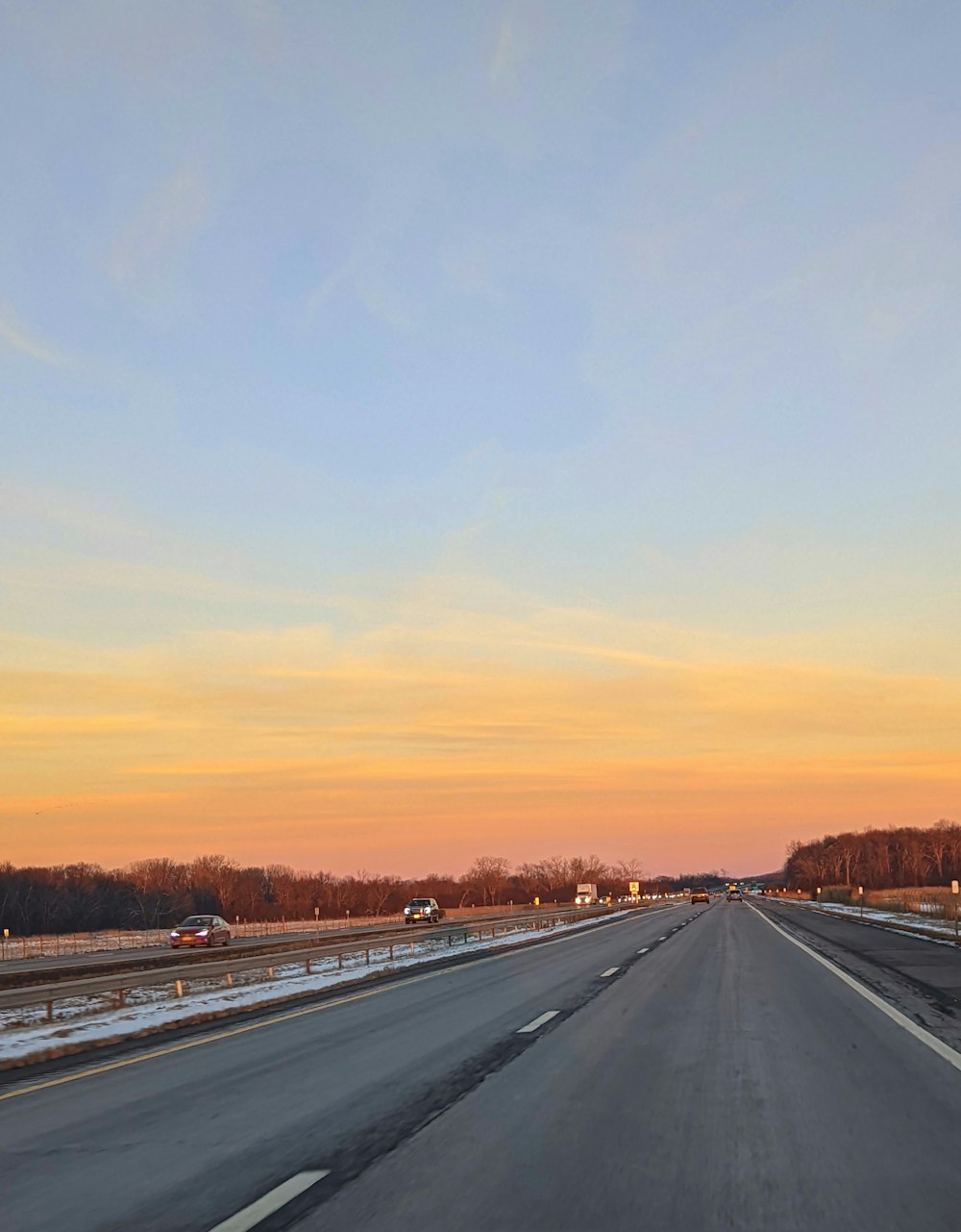 a highway with a few cars driving down it