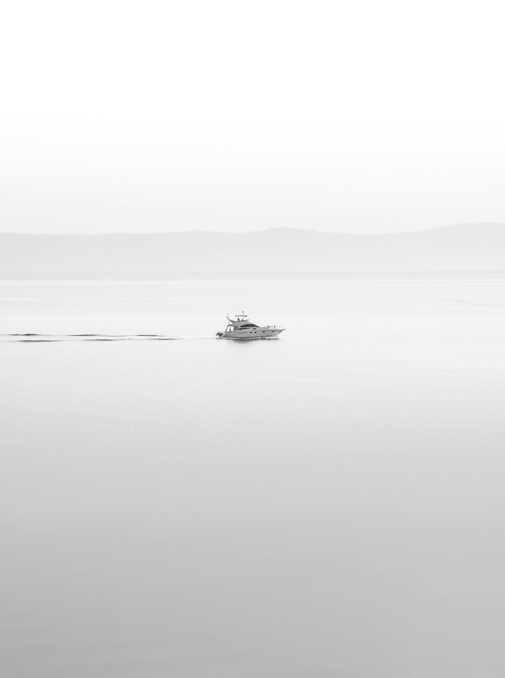 a boat floating in the middle of a large body of water