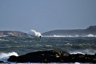 a person riding a surfboard on top of a wave in the ocean