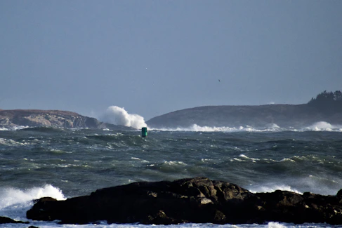 a person riding a surfboard on top of a wave in the ocean