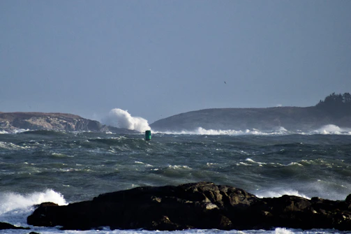 a person riding a surfboard on top of a wave in the ocean