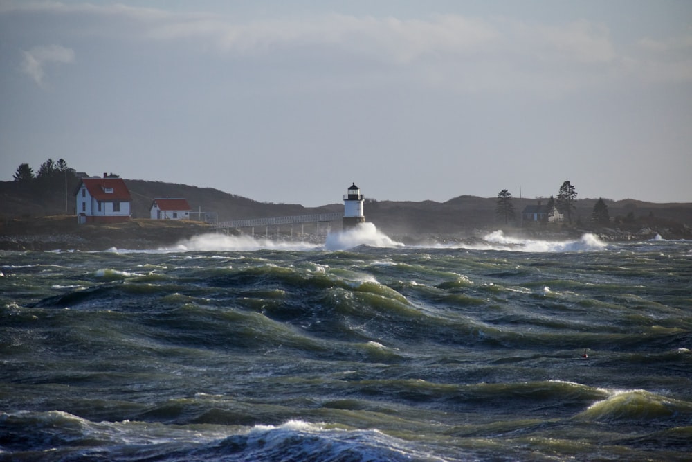 a lighthouse in the middle of a large body of water