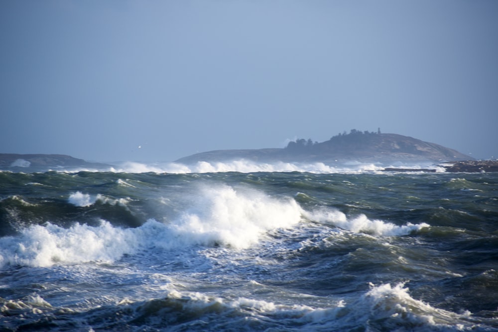 a large body of water with a small island in the background