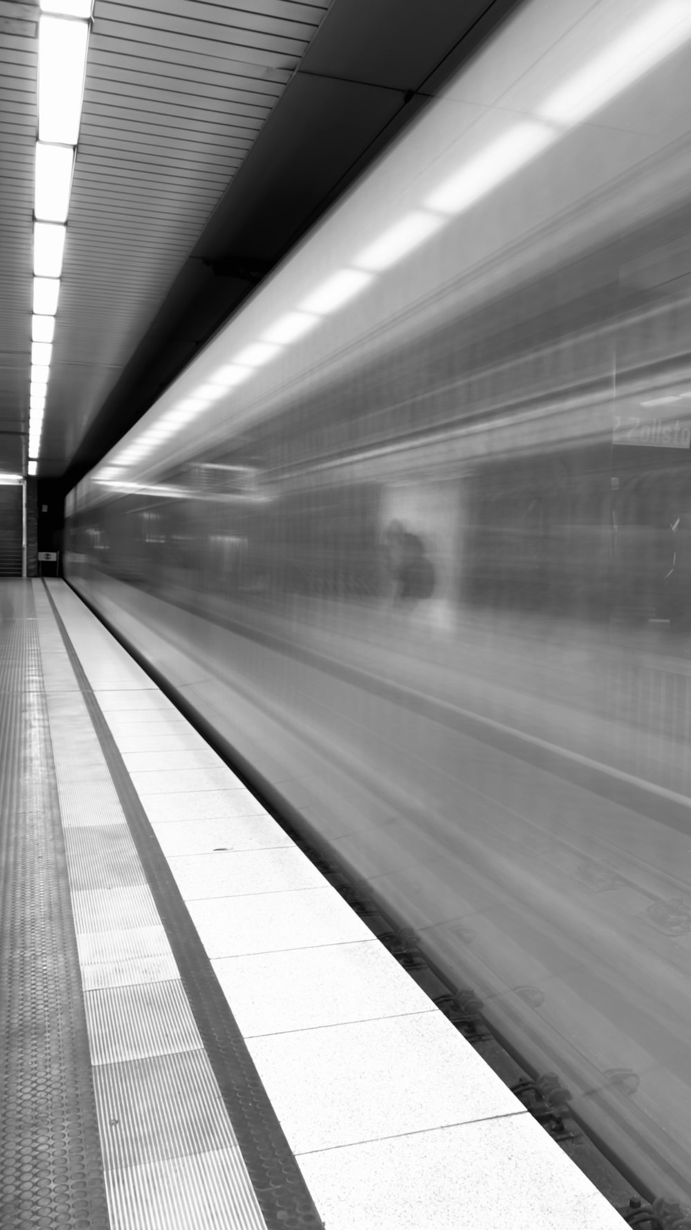 a blurry photo of a train coming in to a station