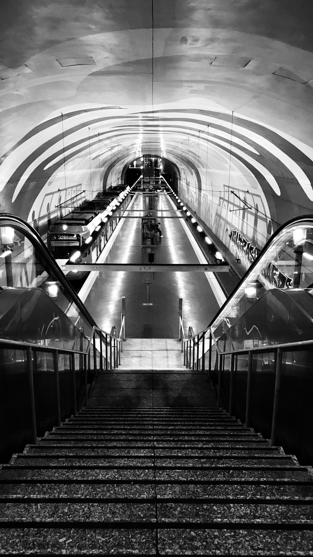 a black and white photo of an escalator